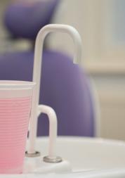 Mouthwash and tap in front of a dentist chair